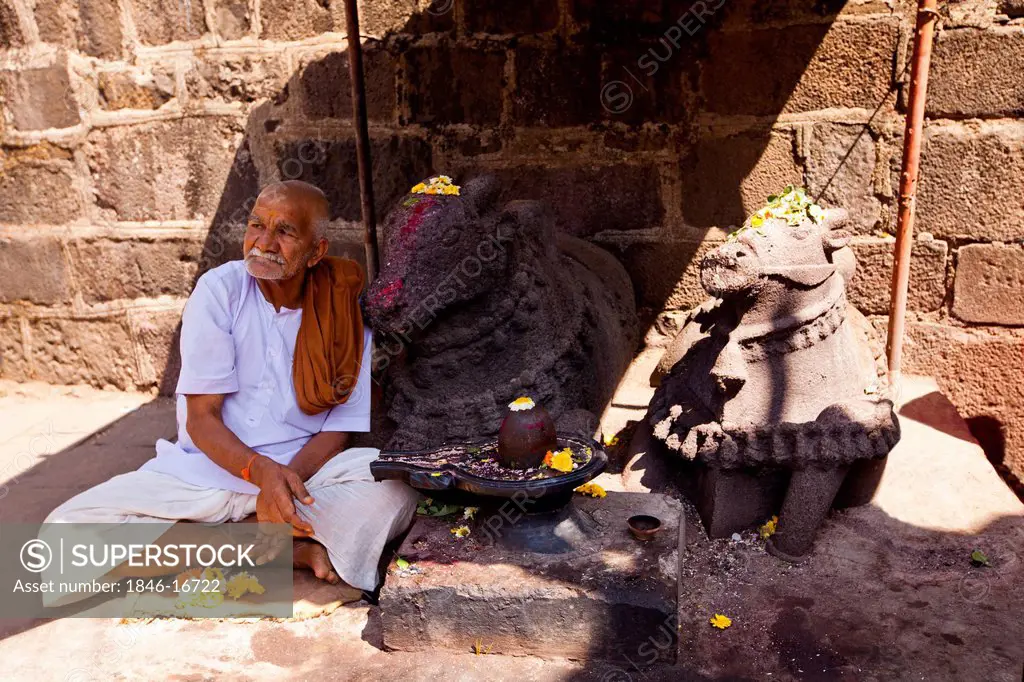 Priest sitting beside Shivling at Bhimashankar Temple, Pune, Maharashtra, India
