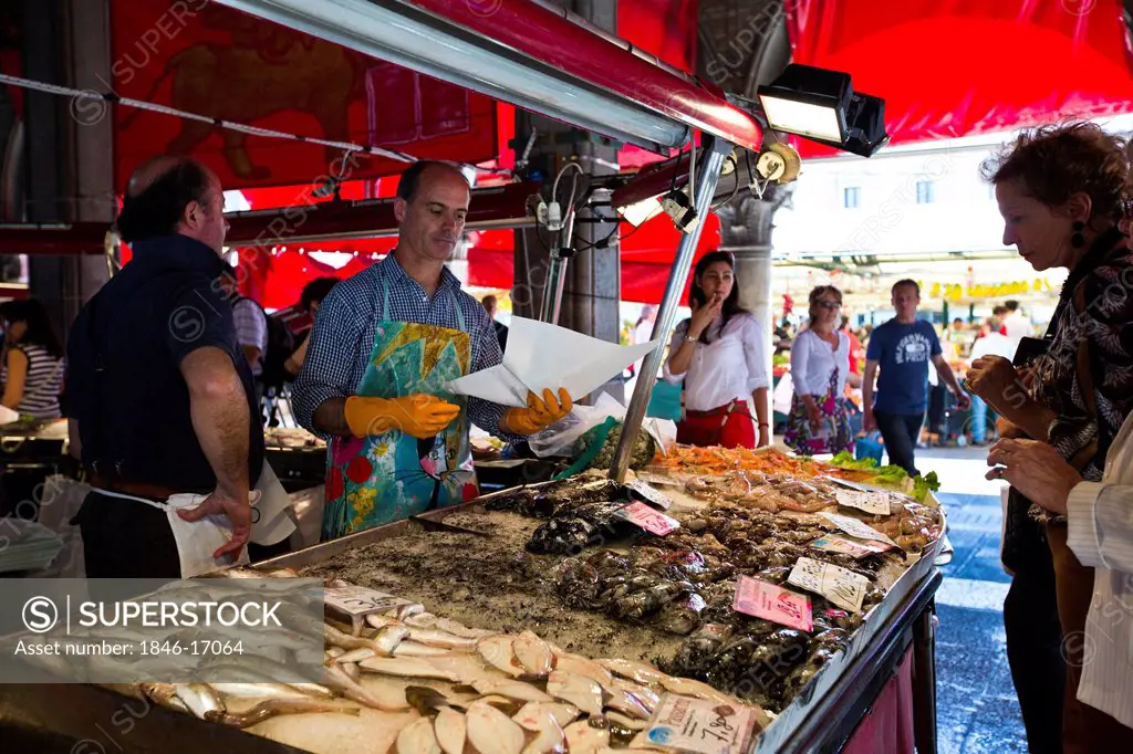 People buying seafood at fish market, Tronchetto Mercato, Venice, Veneto, Italy