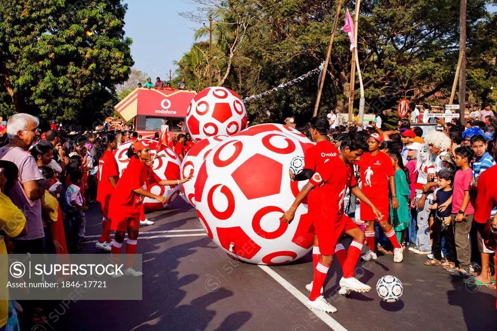 People with sculptures of soccer balls at procession in a carnival, Goa Carnivals, Goa, India