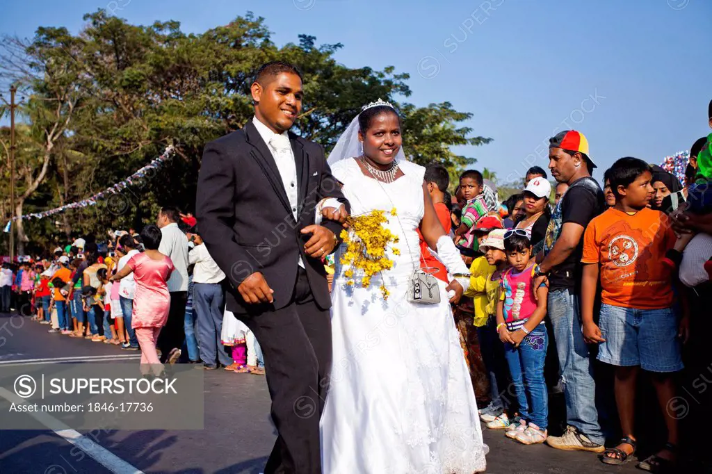 Newlywed couple at traditional procession in a carnival, Goa Carnivals, Goa, India