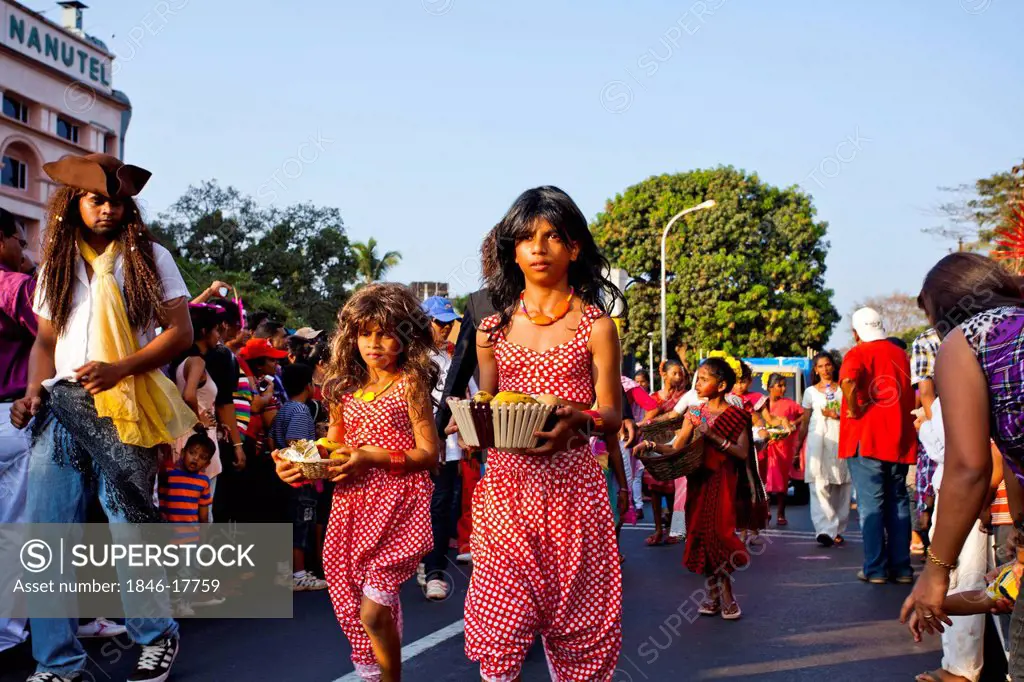 Girls carrying basket at procession in a carnival, Goa Carnivals, Goa, India