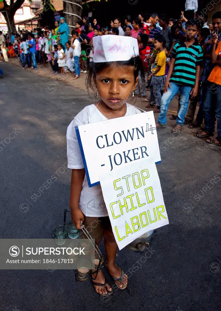 Girl protesting against child labor during a procession in a carnival, Goa Carnivals, Goa, India