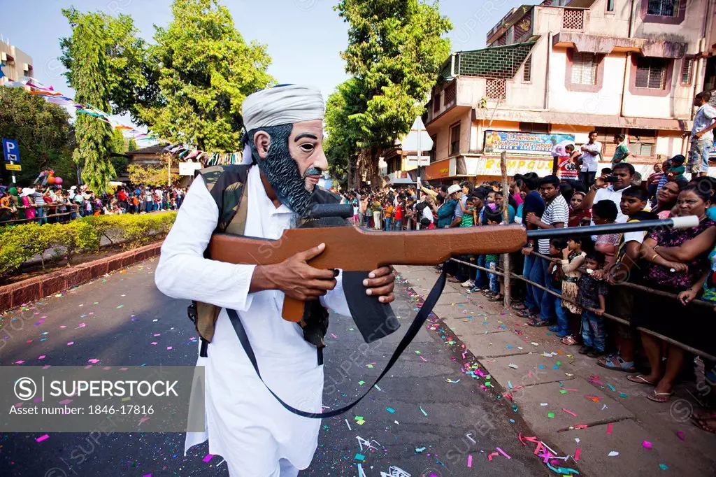 Man acting as terrorist during a procession in a carnival, Goa Carnivals, Goa, India