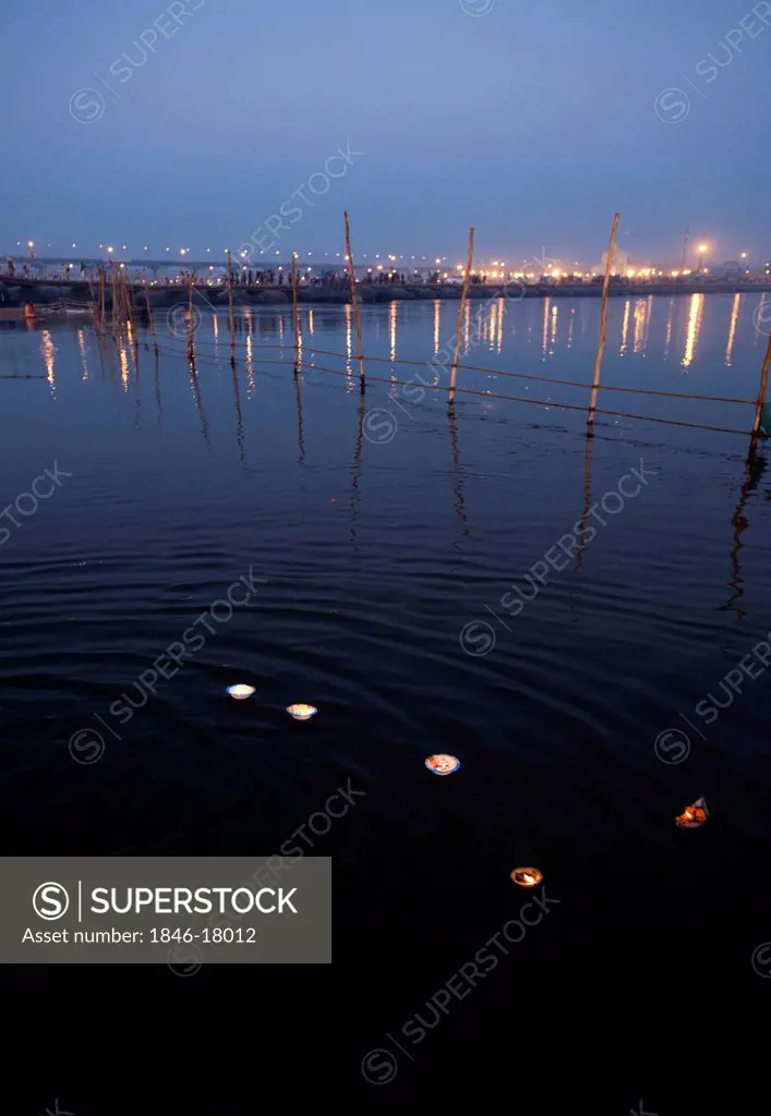 Burning oil lamps floating on Ganges River at Maha Kumbh, Allahabad, Uttar Pradesh, India