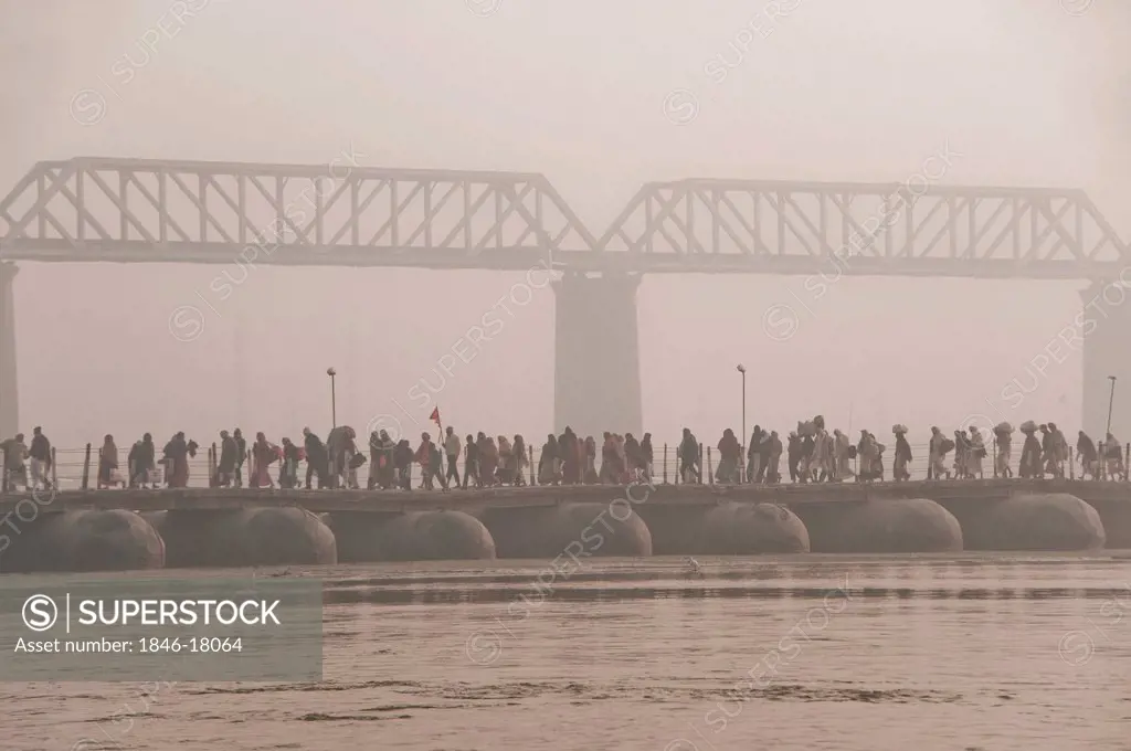 Pilgrims walking on a bridge at Maha Kumbh, Allahabad, Uttar Pradesh, India