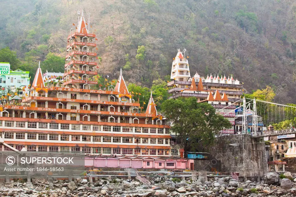 Facade of a multi-storied temple at the riverside, Trayambakeswar Temple, Lakshman Jhula, River Ganges, Rishikesh, Dehradun District, Uttarakhand, Ind...