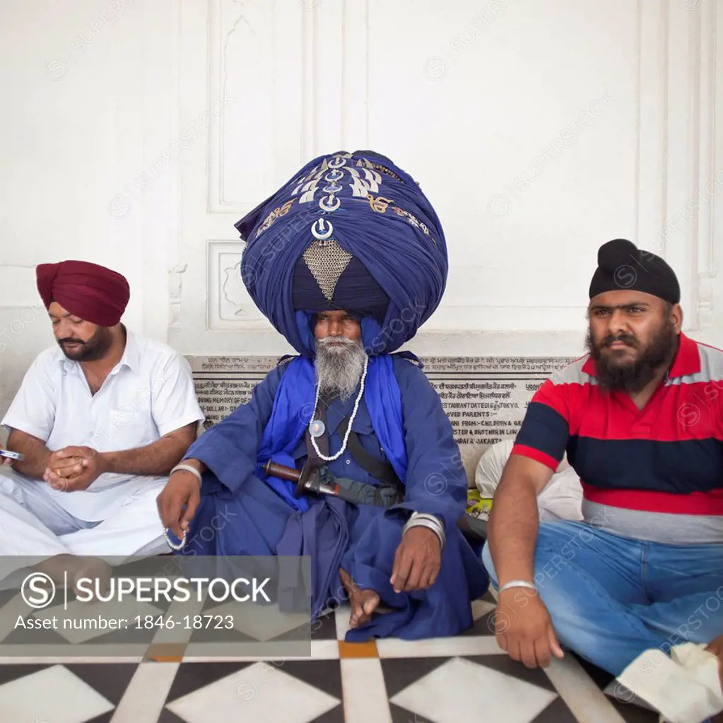 Nihang Sikh sitting in traditional religious clothing, Golden Temple, Amritsar, Punjab, India