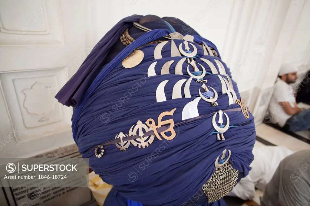 Close-up of the turban of a Nihang Sikh with religious symbols, Golden Temple, Amritsar, Punjab, India