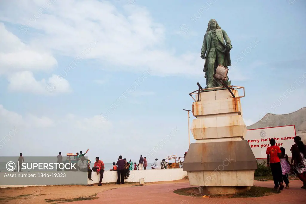 Tourists and monument on beach, Pondicherry, India