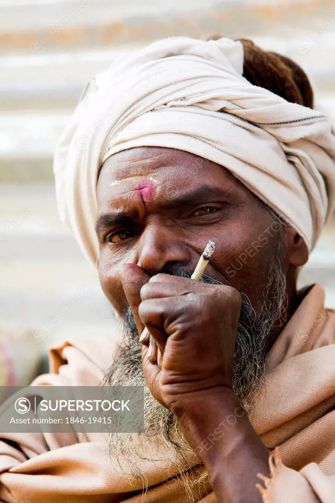Sadhu smoking in Kumbha Mela, Allahabad, Uttar Pradesh, India