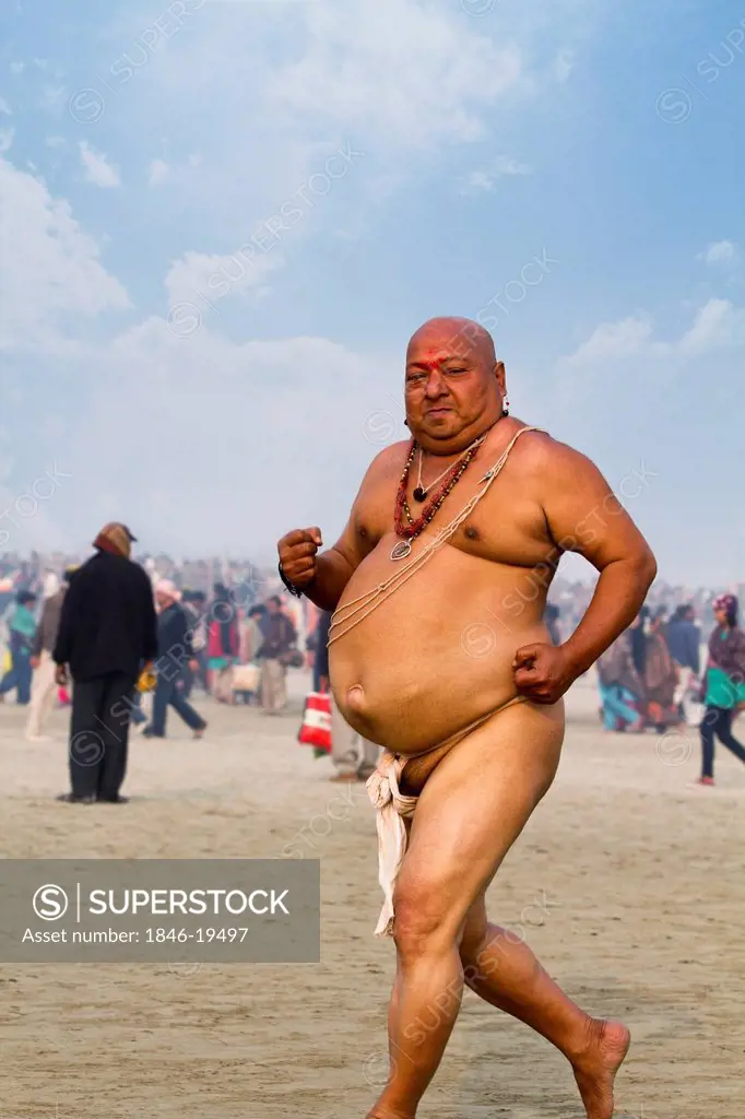 Sadhu running during the first royal bath procession in Kumbh Mela festival, Allahabad, Uttar Pradesh, India