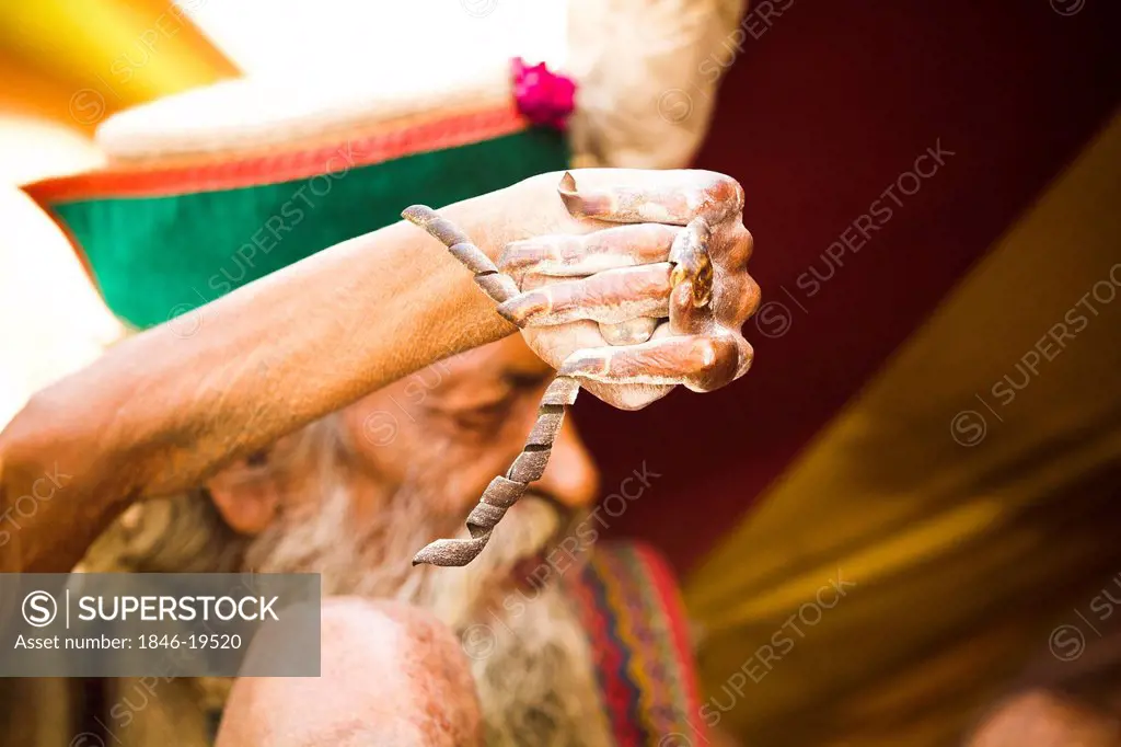 Sadhu displaying his twisted nails during the first royal bath procession in Kumbh Mela festival, Allahabad, Uttar Pradesh, India