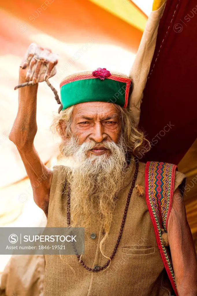 Portrait of a Sadhu displaying his twisted nails during the first royal bath procession in Kumbh Mela festival, Allahabad, Uttar Pradesh, India