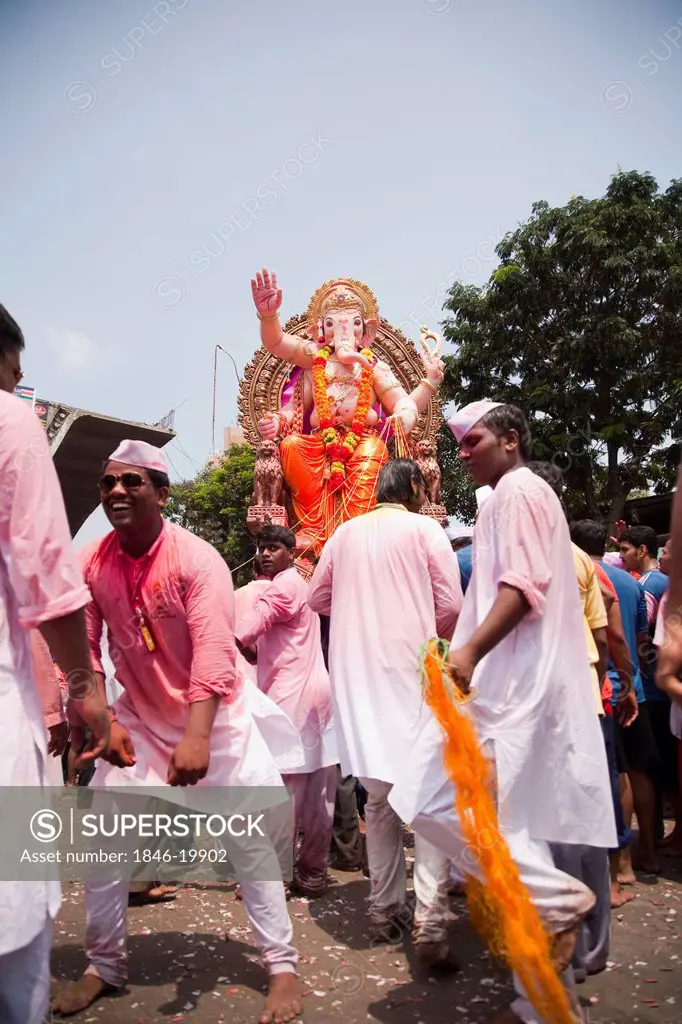 People dancing at religious procession during Ganpati visarjan ceremony, Mumbai, Maharashtra, India