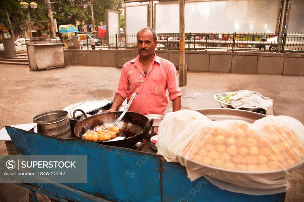 Chef preparing Indian snacks at a food stall, Chandni Chowk, Old Delhi, India