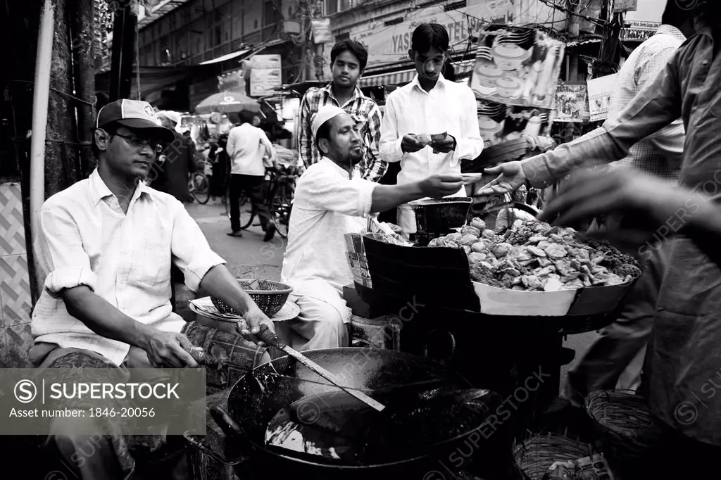 Chefs preparing Indian snacks at a food stall, Chandni Chowk, Old Delhi, India