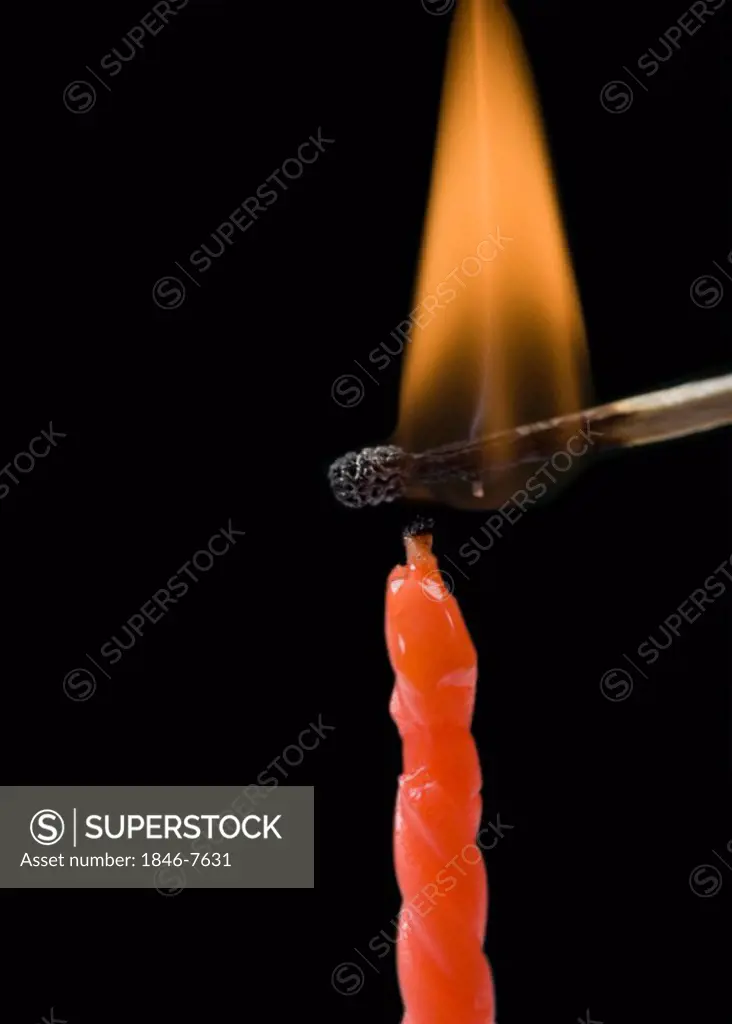 Matchstick lighting a birthday candle