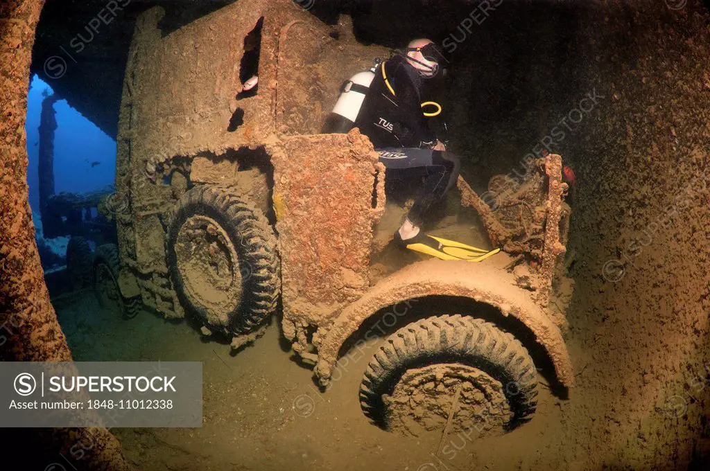 Scuba diver looking at truck on shipwreck SS Thistlegorm, Red Sea, Egypt