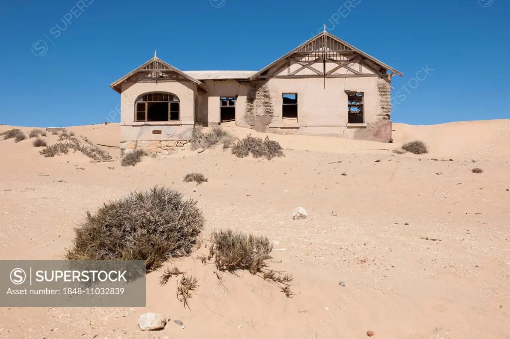 House of a former diamond miners settlement that is slowly covered by the sand of the Namib Desert, Kolmanskop, Karas, Namibia