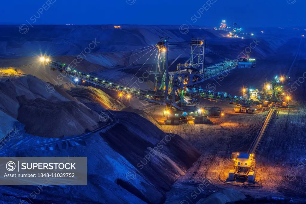 Stacker and conveyor in the Garzweiler open pit at night, Grevenbroich, North Rhine-Westphalia, Germany