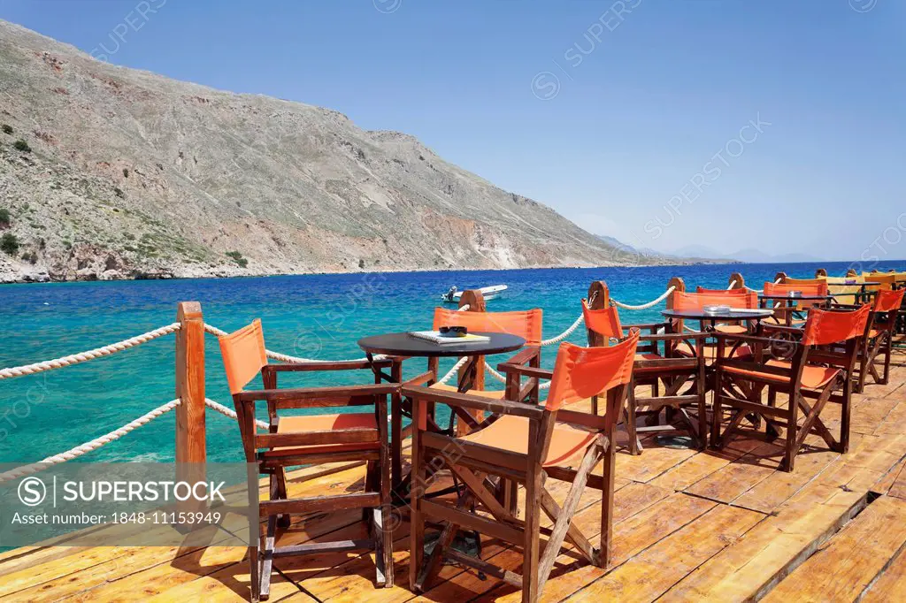 Cafe terrace on the harbour promenade, Loutro, South Crete, Crete, Greece
