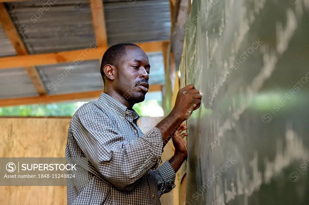 Teacher writing on the blackboard, Fort National, Port-au-Prince, Haiti