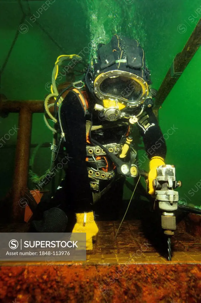 Professional off shore diver in training, drilling underwater, The Underwater Center, Fort Williams, Loch Linnhe, Scotland, Atlantic