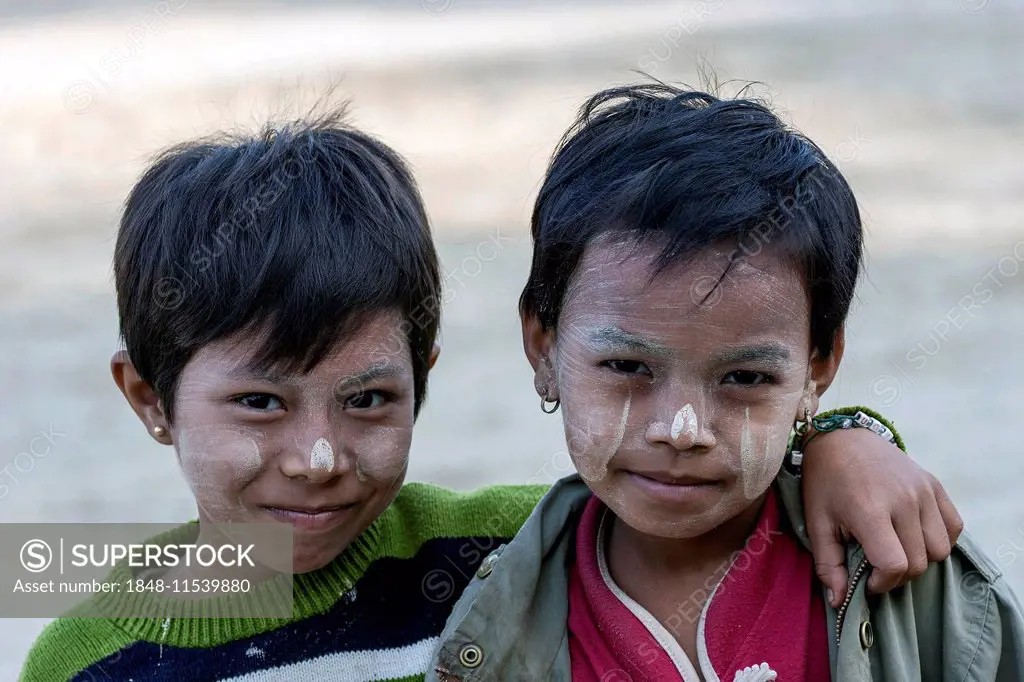 Two children with Thanaka paste on their faces, in Bagan, Myanmar