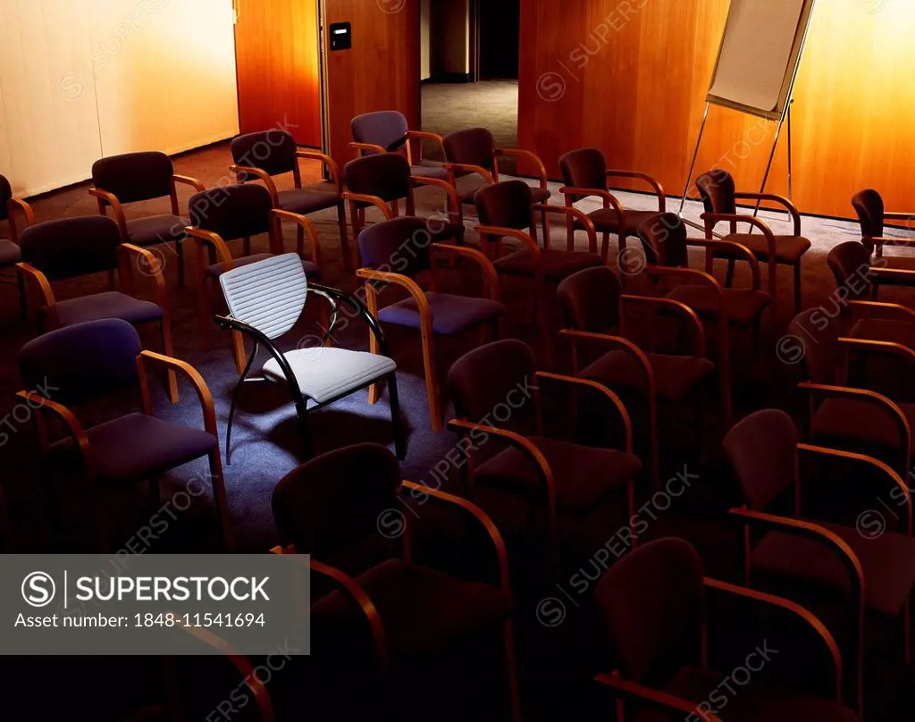 Chairs in a lecture hall, a chair is illuminated