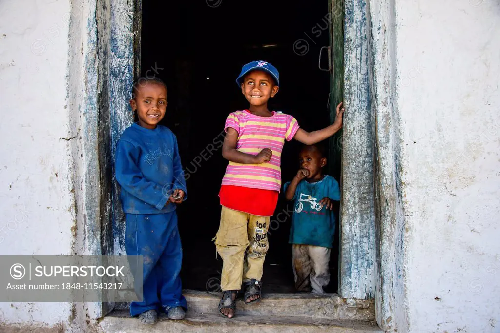 Young kids standing in a door frame, near Keren, Eritrea
