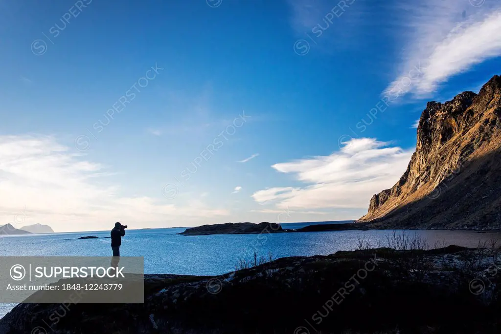 Photographer standing on a rock, Tangstad, Lofoten, Norway