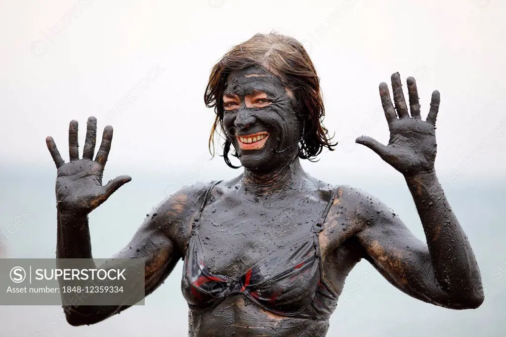 Female tourist covered in salty mud from the Dead Sea, Suwayma, Jordan