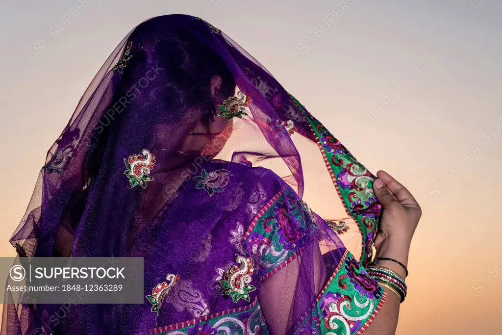 Woman wearing a purple sari, Vrindavan, Uttar Pradesh, India