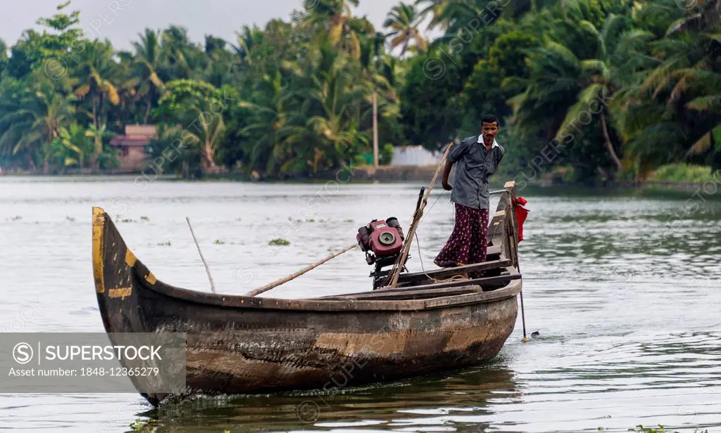 Indian man steering a boat, Backwaters, Alappuzha District, Alleppey, Kerala, India