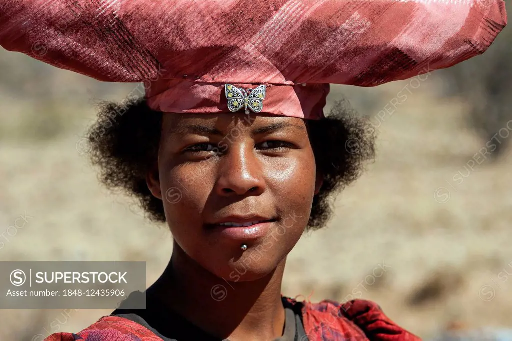 Native Herero woman with typical hat in Uis, Namibia