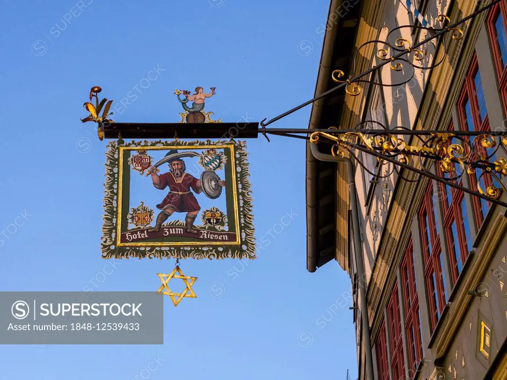 Hanging sign Hotel zum Riesen at the Gasthaus zum Riesen tavern, Germany's oldest inn, built in the 12th century, historic centre, Miltenberg, Bavaria...