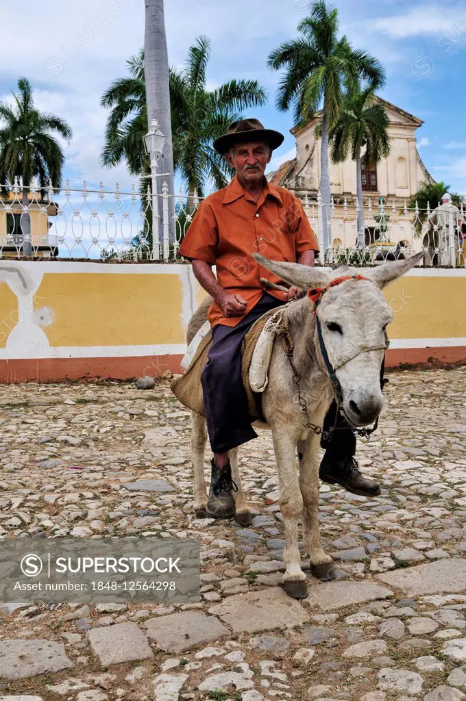 Man riding a donkey, Plaza Mayor, historic centre of Trinidad, Sancti Spíritus Province, Cuba