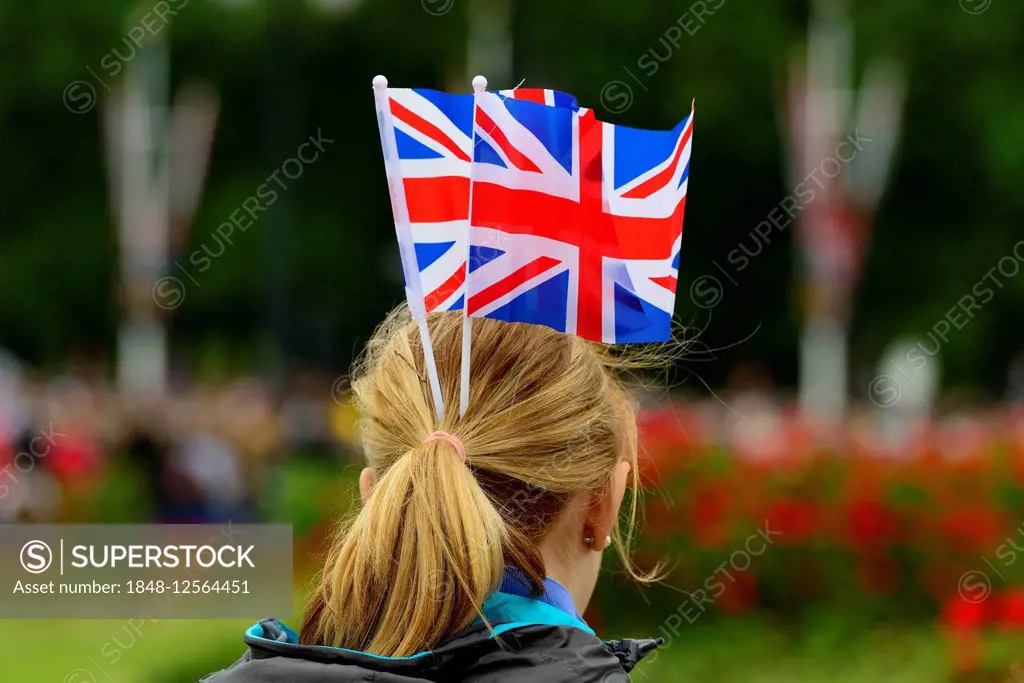Female fan of the Queen with Union Jack flags on her head, Trooping the Colour, annual military parade to celebrate the birthday of Queen Elizabeth II...