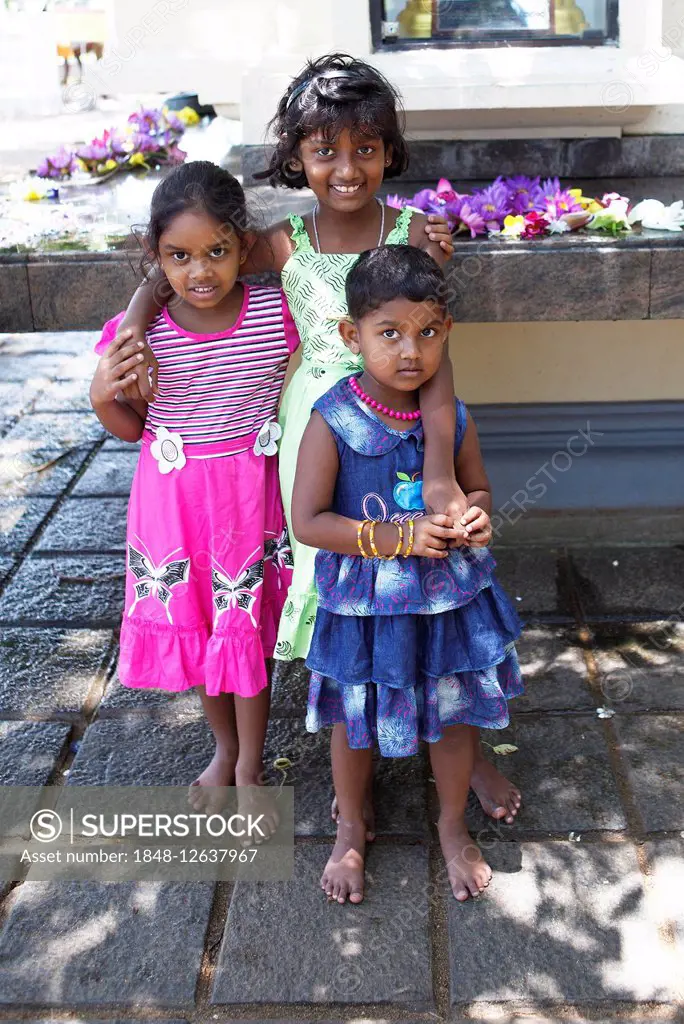 Young girls, barefoot in the temple hall Dagoba, Kalutara, Western Province, Ceylon, Sri Lanka