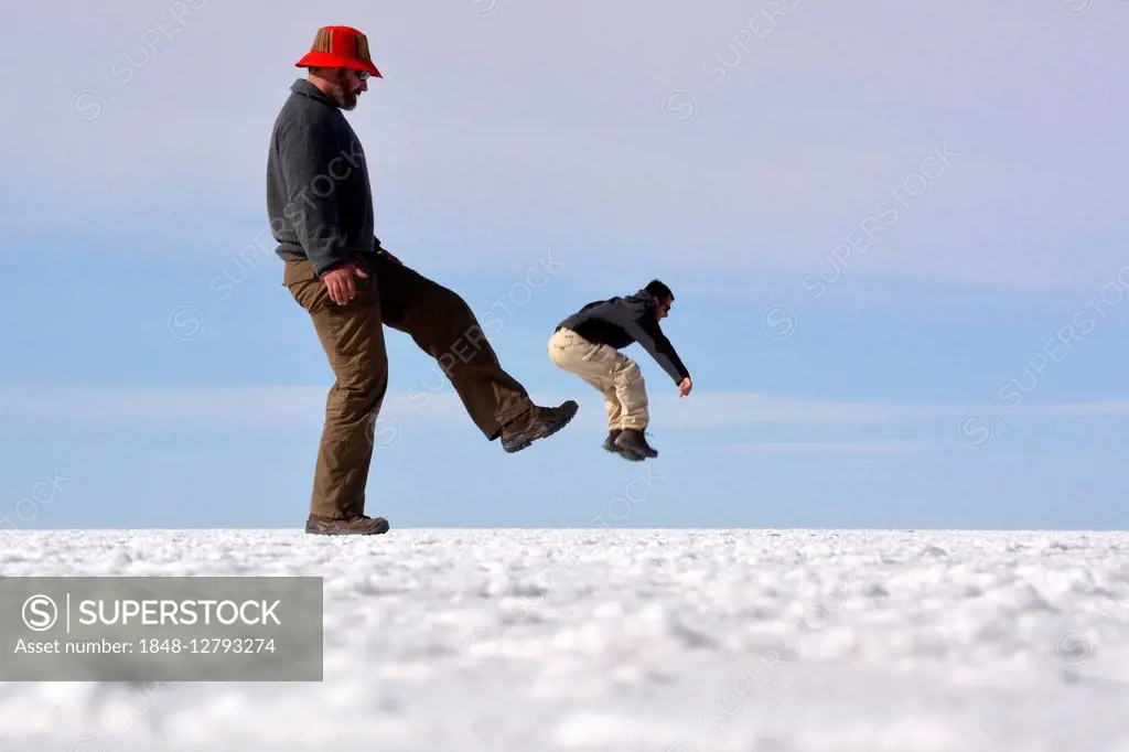 Optical illusion, man being kicked, Salar de Uyuni, Bolivia