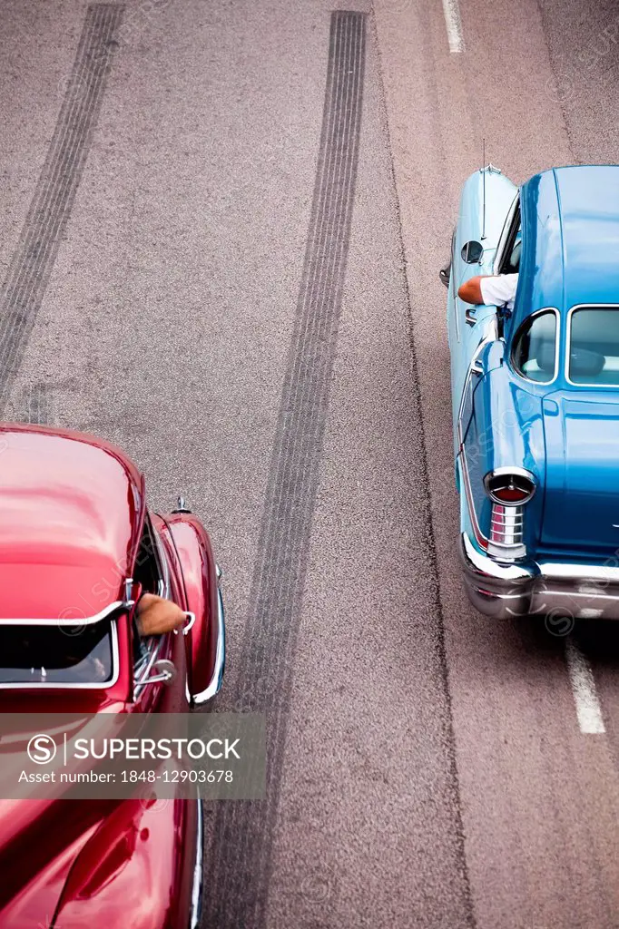 Two American classic cars on the road, Power Meet oldtimer meeting, Västerås, Västmanland, Sweden