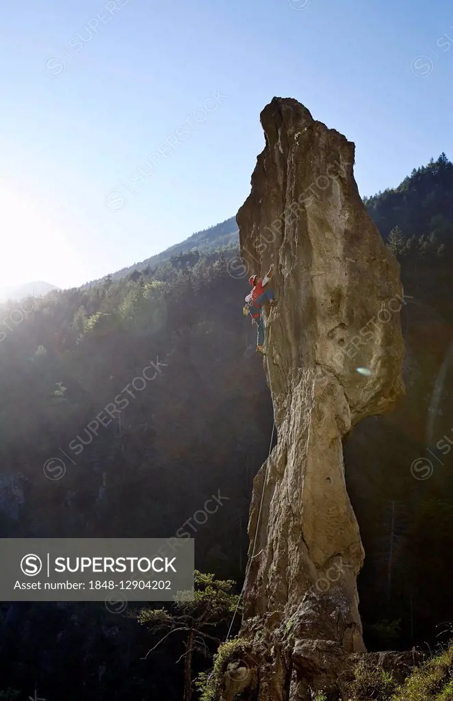 Sport climber on a rocky pinnacle, Ehnbachklamm gorge, Zirl, Tyrol, Austria