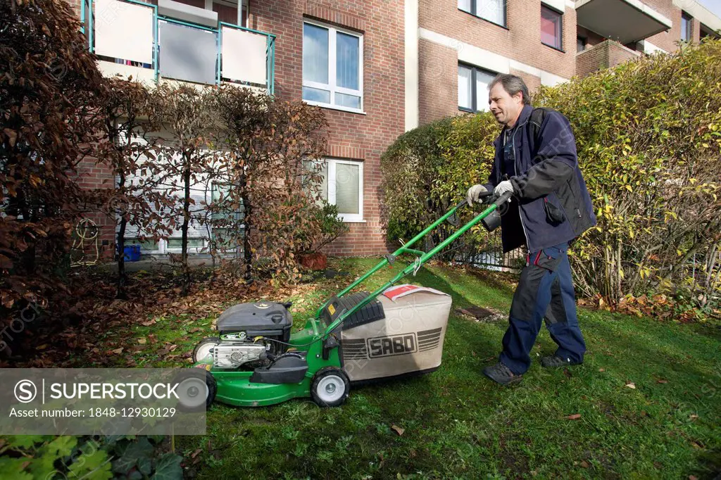 Janitor with mowing lawn lawnmower, Janitorial Service, Germany