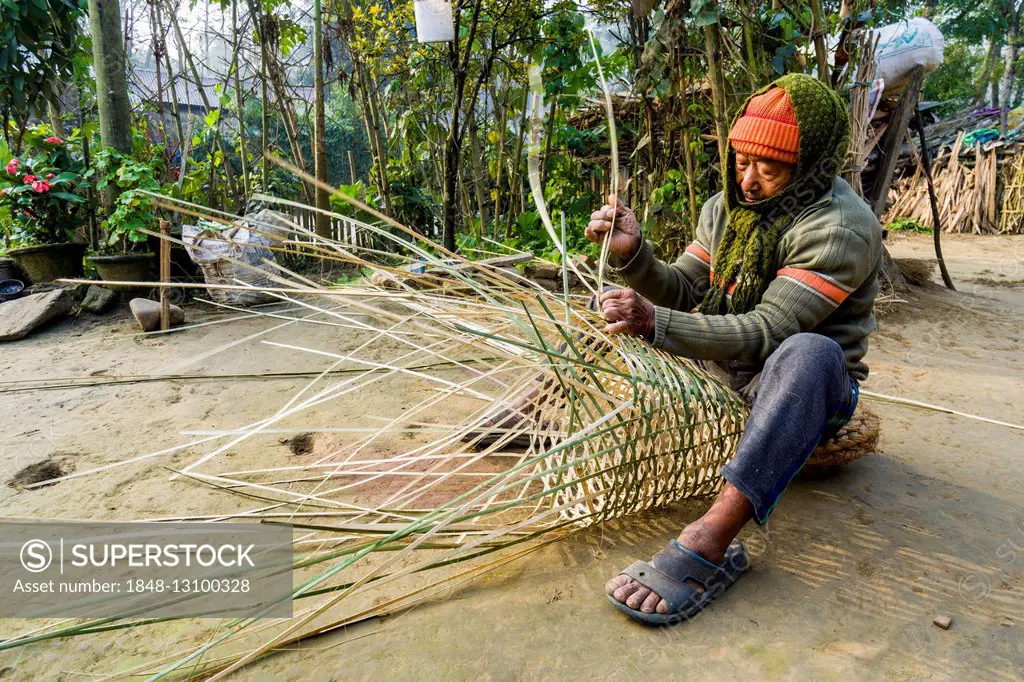 A man is weaving a bamboo basket, Sauraha, Chitwan, Nepal