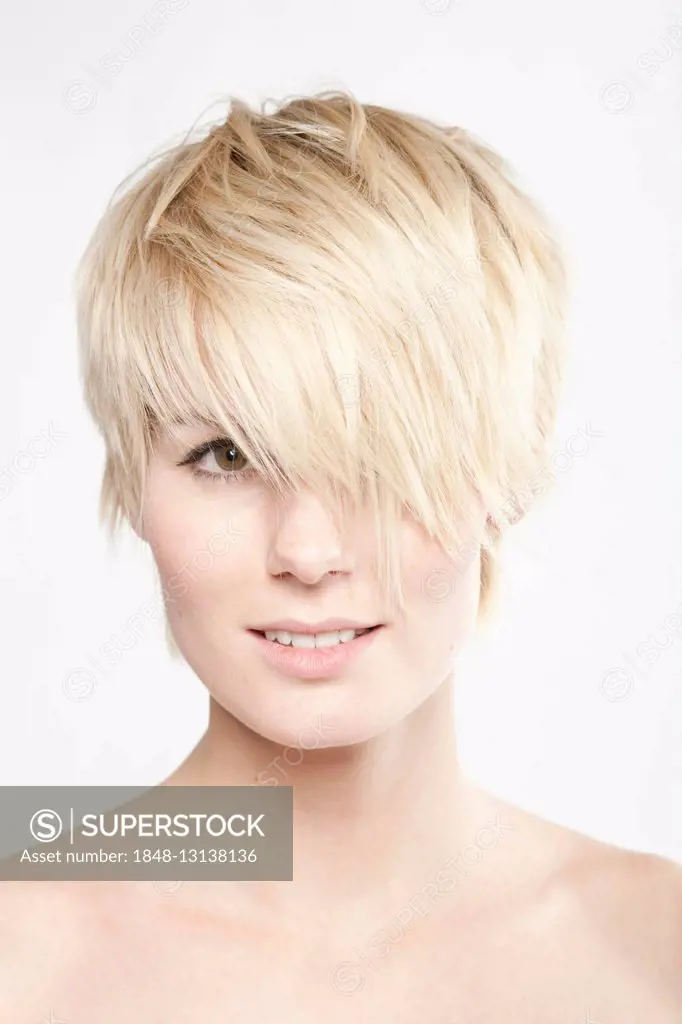 Young blond woman with short hair looking into the camera