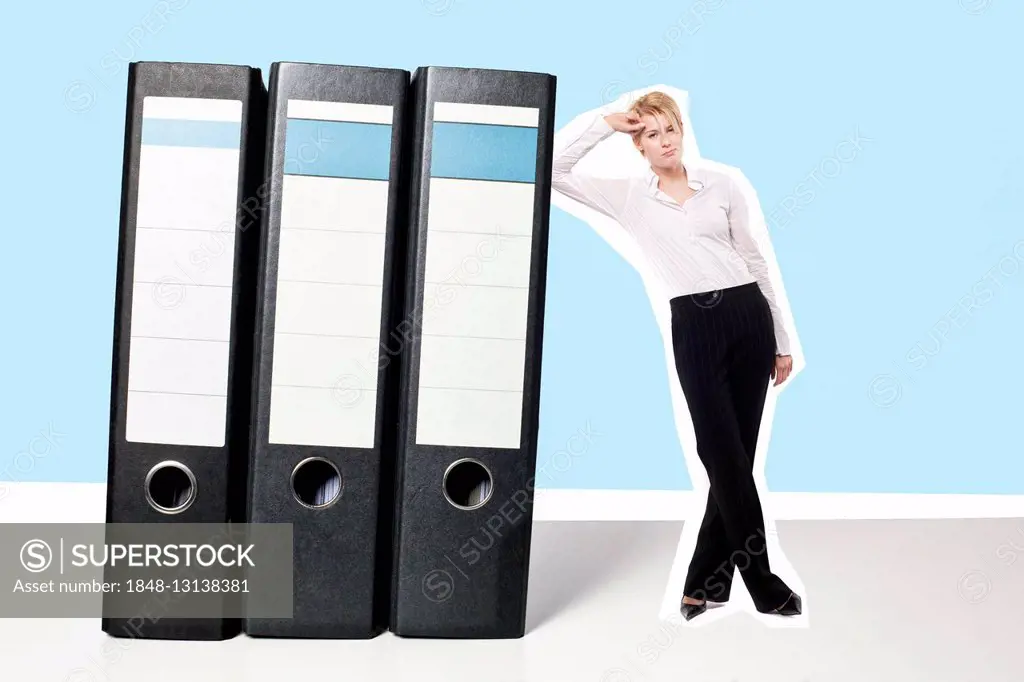 Annoyed young business woman leaning on giant folders, composing