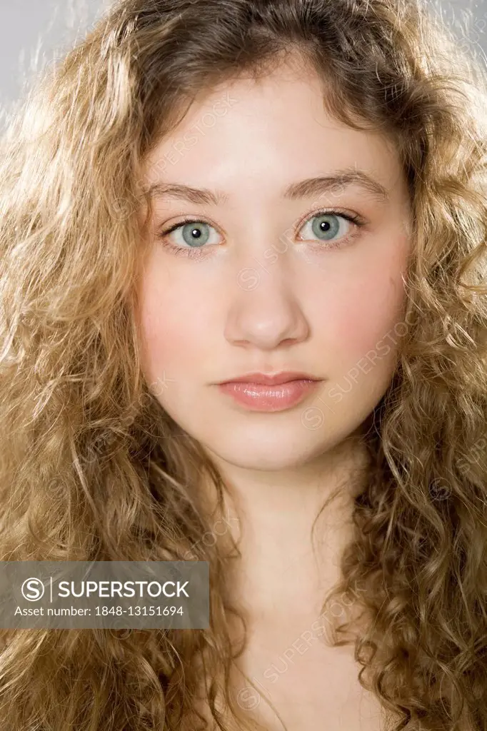 Portrait of a young woman with curly hair