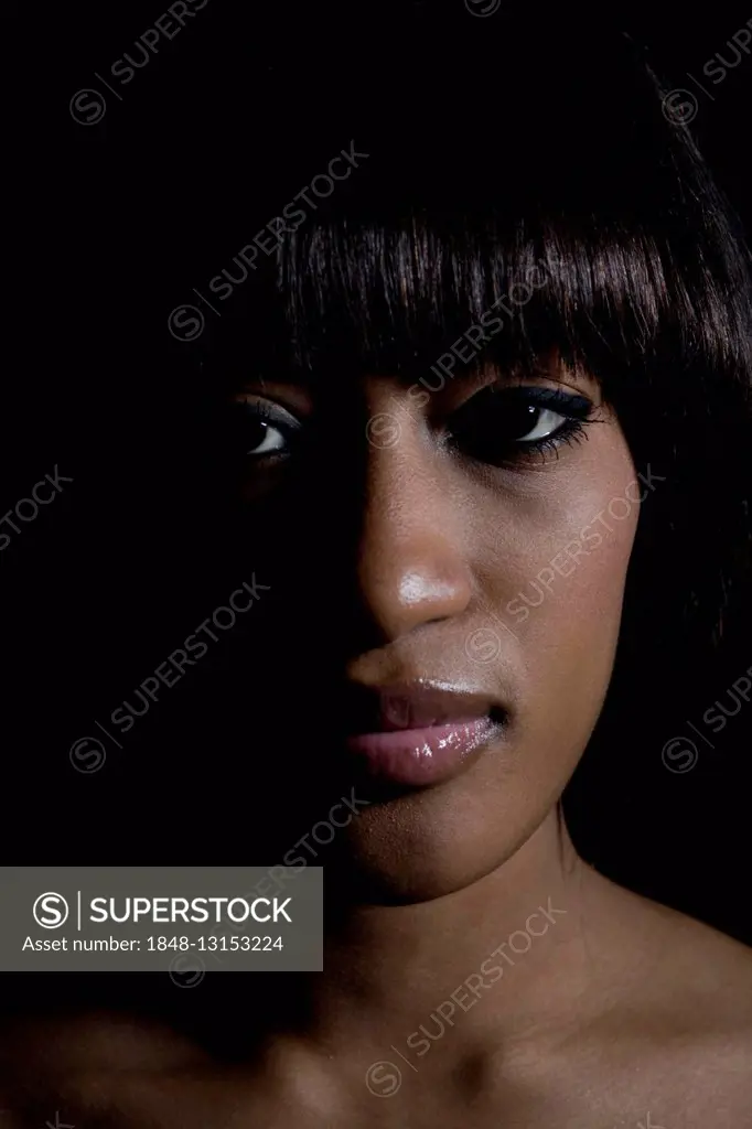 Portrait of a young, dark-skinned woman looking serious