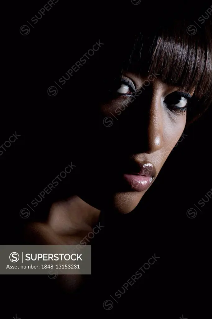 Portrait of a young, dark-skinned woman looking serious