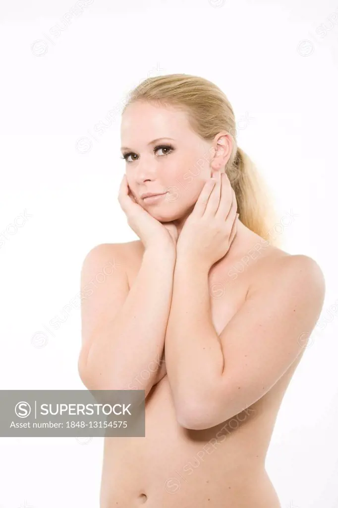 Young, long-haired blonde woman, bare upper body, in front of white backdrop